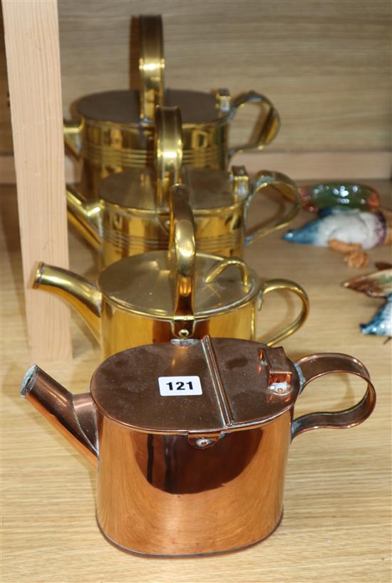 Three brass watering cans and a similar copper watering can